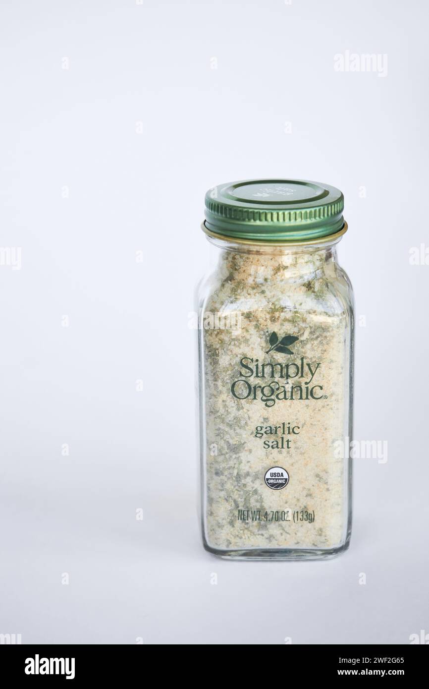 Simply Organic brand garlic salt seasoning. Glass jar of spices. Organic ingredients: Sea salt, garlic, rice concentrate, parsley. iHerb store, online Stock Photo