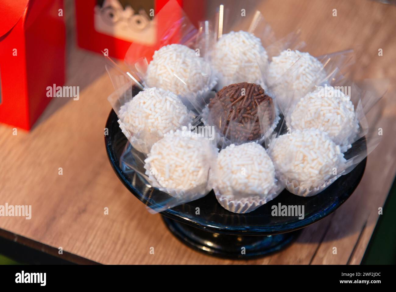 A delicious assortment of cake pops and candy bars fills this dessert dish Stock Photo