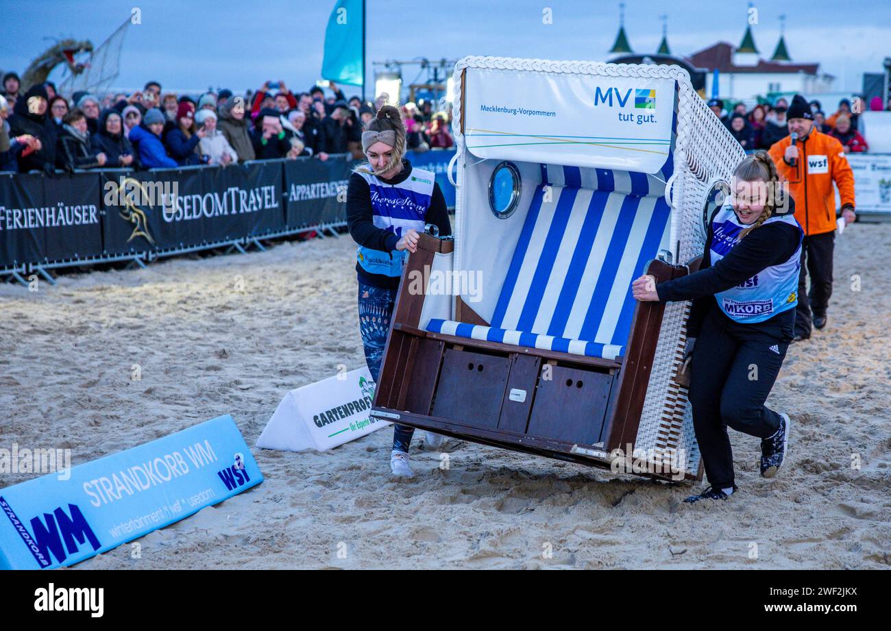 Ahlbeck, Germany. 27th Jan, 2024. A women's team runs in one of the finals at the 16th Beach Chair World Championships. In the competition, teams of two have to drag a beach chair weighing around 60 kilograms over a 20-meter course over Baltic Sea sand to the finish line. The record has stood at 4.91 seconds for years. Credit: Jens Büttner/dpa/Alamy Live News Stock Photo