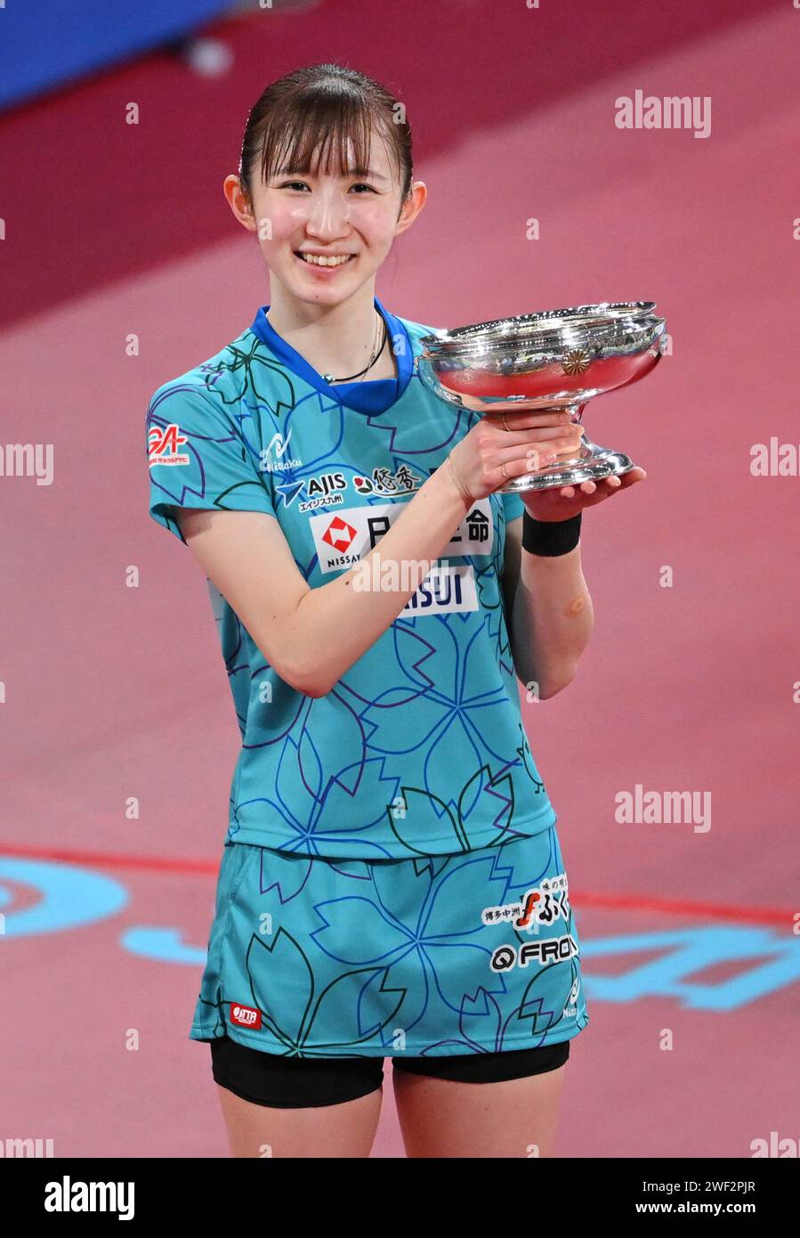 Hina Hayata of Japan is given a victory trophy after winning women's ...