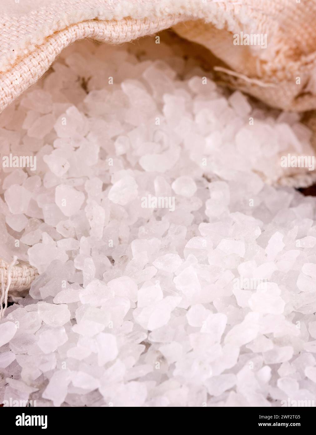 The sea salt in jute sack close up. Stile life concept Stock Photo