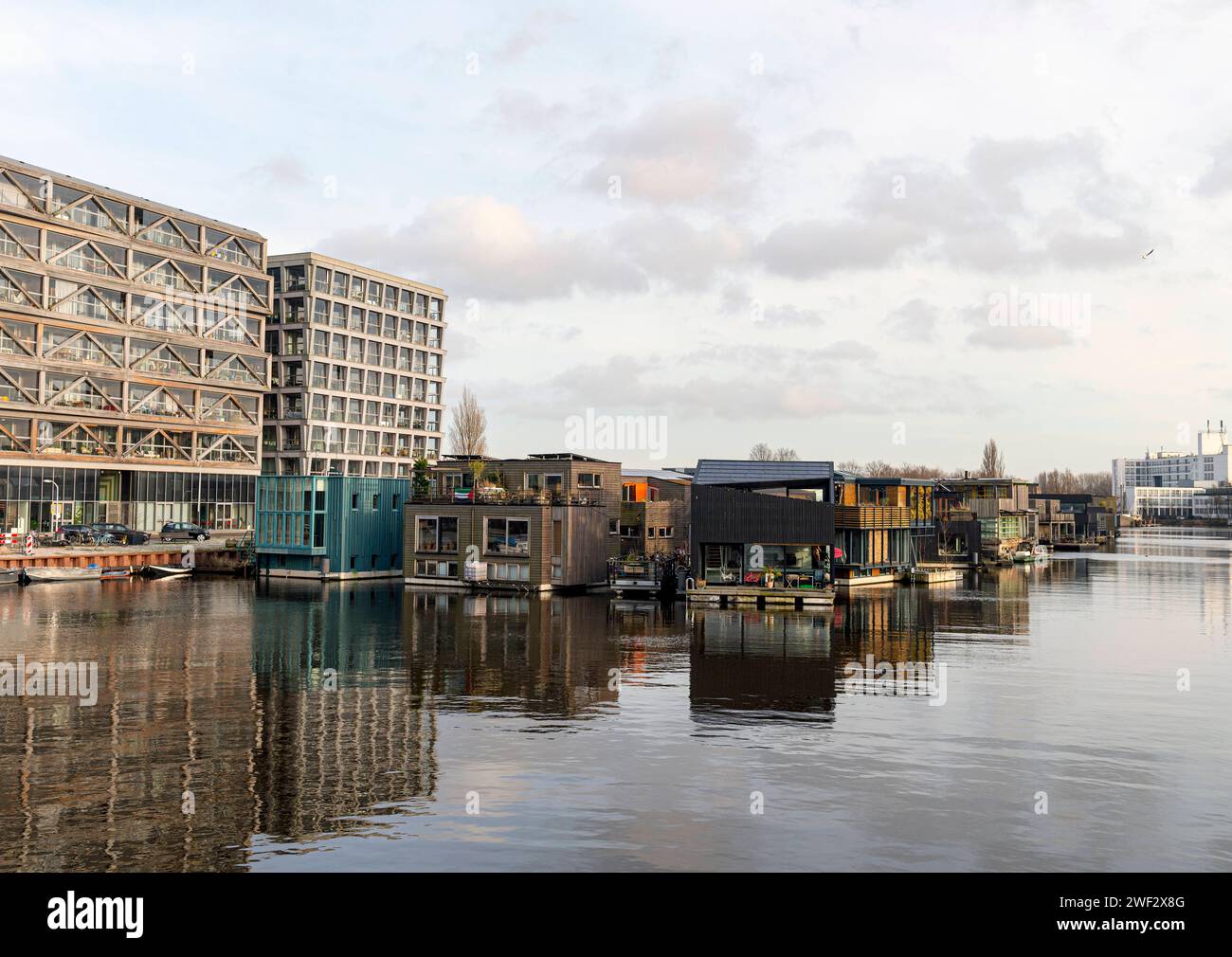 Amsterdam The Netherlands 27th January 2024 Schoonschip houseboats on the Johan van Hasseltkanaal. The Schoonschip complex was developed by the residents themselves with a goal of minimizing their environmental impact. dutch, nl, woonark, woonboot, Stock Photo