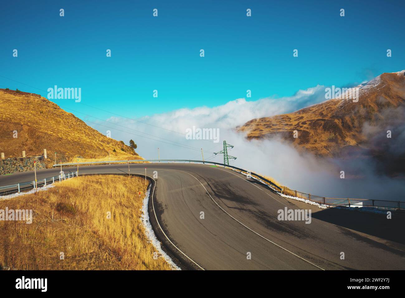 Alpine winding highway above the clouds. Pyrenees, Andorra, Europe Stock Photo