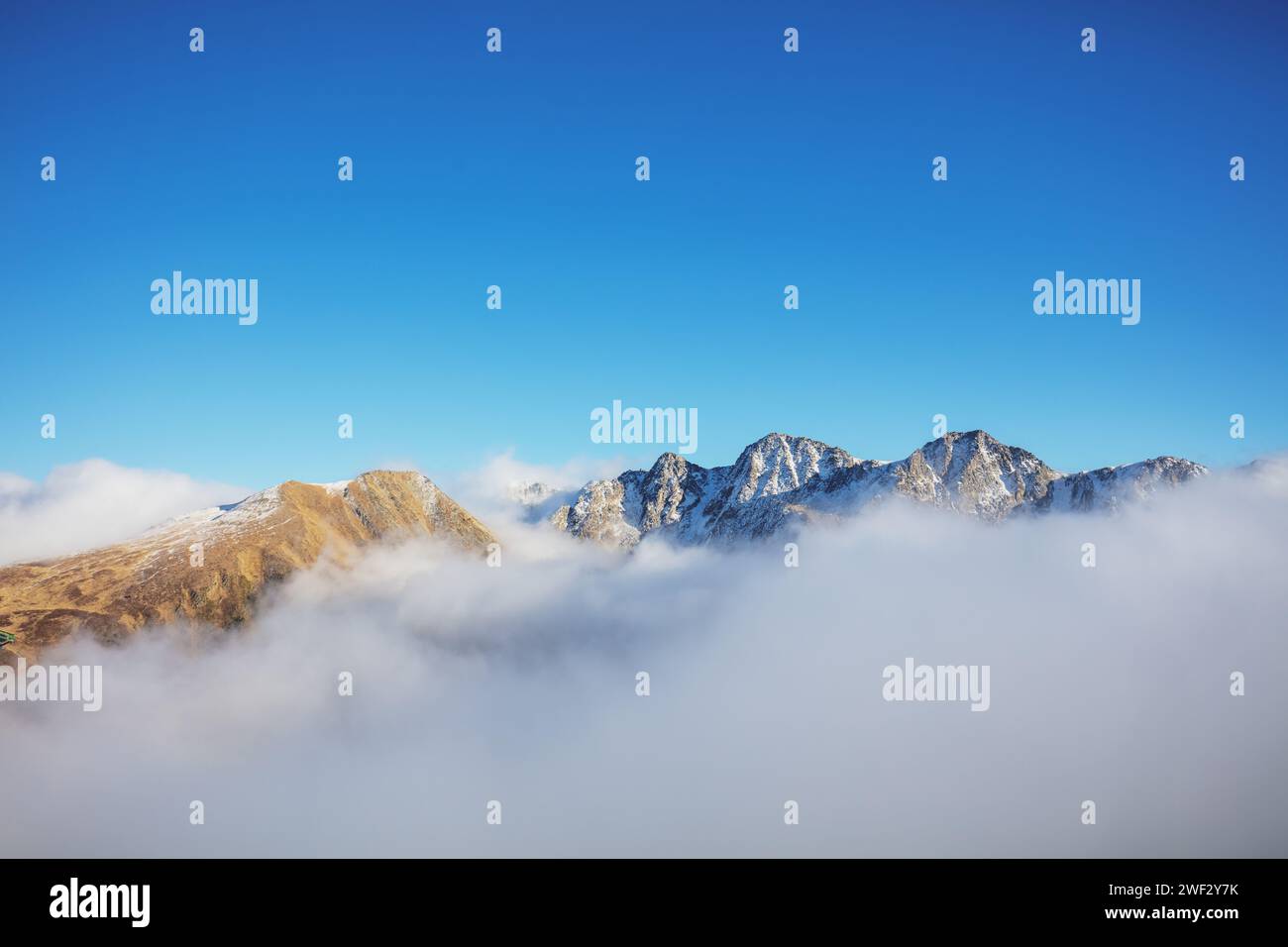 Mountains minimalist landscape. Peaks of the mountains above the clouds. Pyrenees, Andorra, Europe Stock Photo