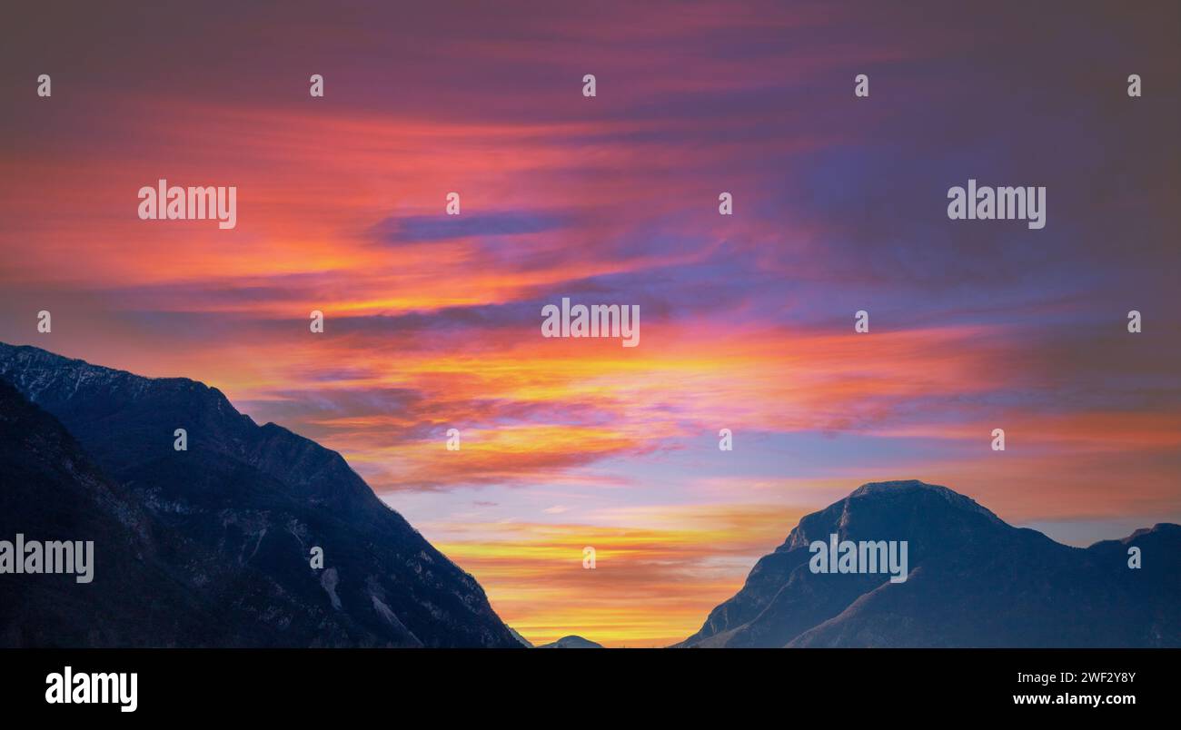 Beautiful mountains against sunset sky.  Silhouette of mountains peaks during sunset Stock Photo