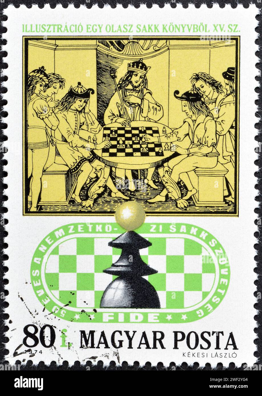 Cancelled postage stamp printed by Hungary, that shows Chess Players, 15th-century Illustration from Italian Chess Book and Bishop. Stock Photo