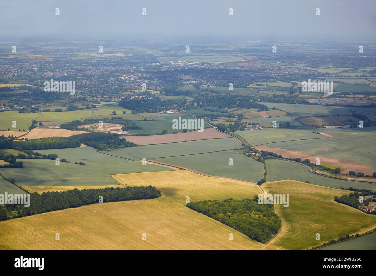 The aerial view of the fields and cousy settlements located in the lowlands surrounding county and university town of Cambridge. Cambridgeshire. Unite Stock Photo