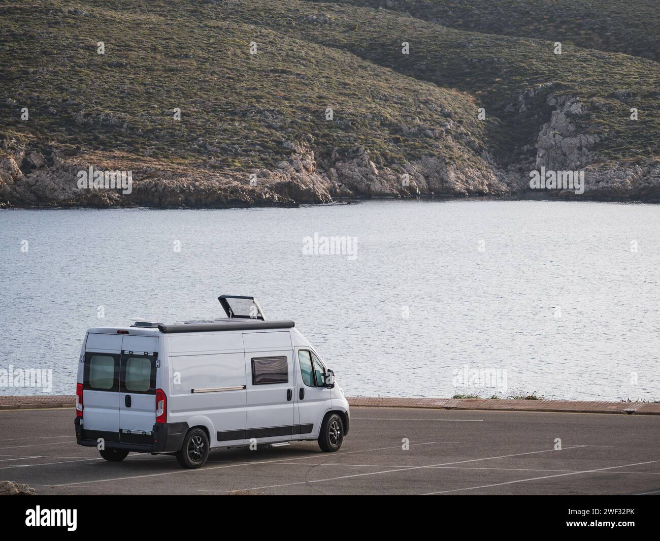 Camper van parked by the sea. Road trip, nomadic lifestyle Stock Photo ...