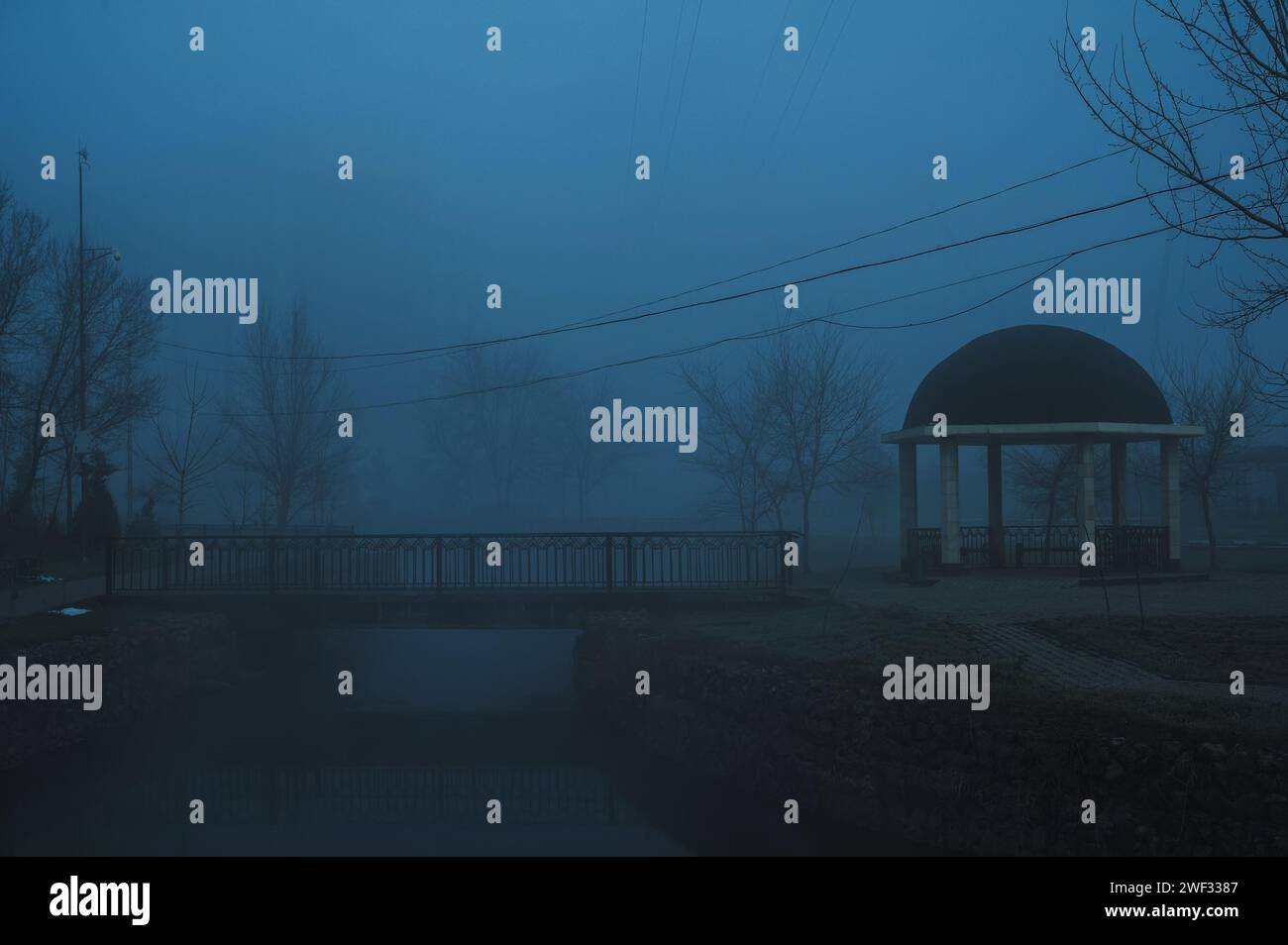 misty landscape with a gazebo by the river on an autumn morning in the ...