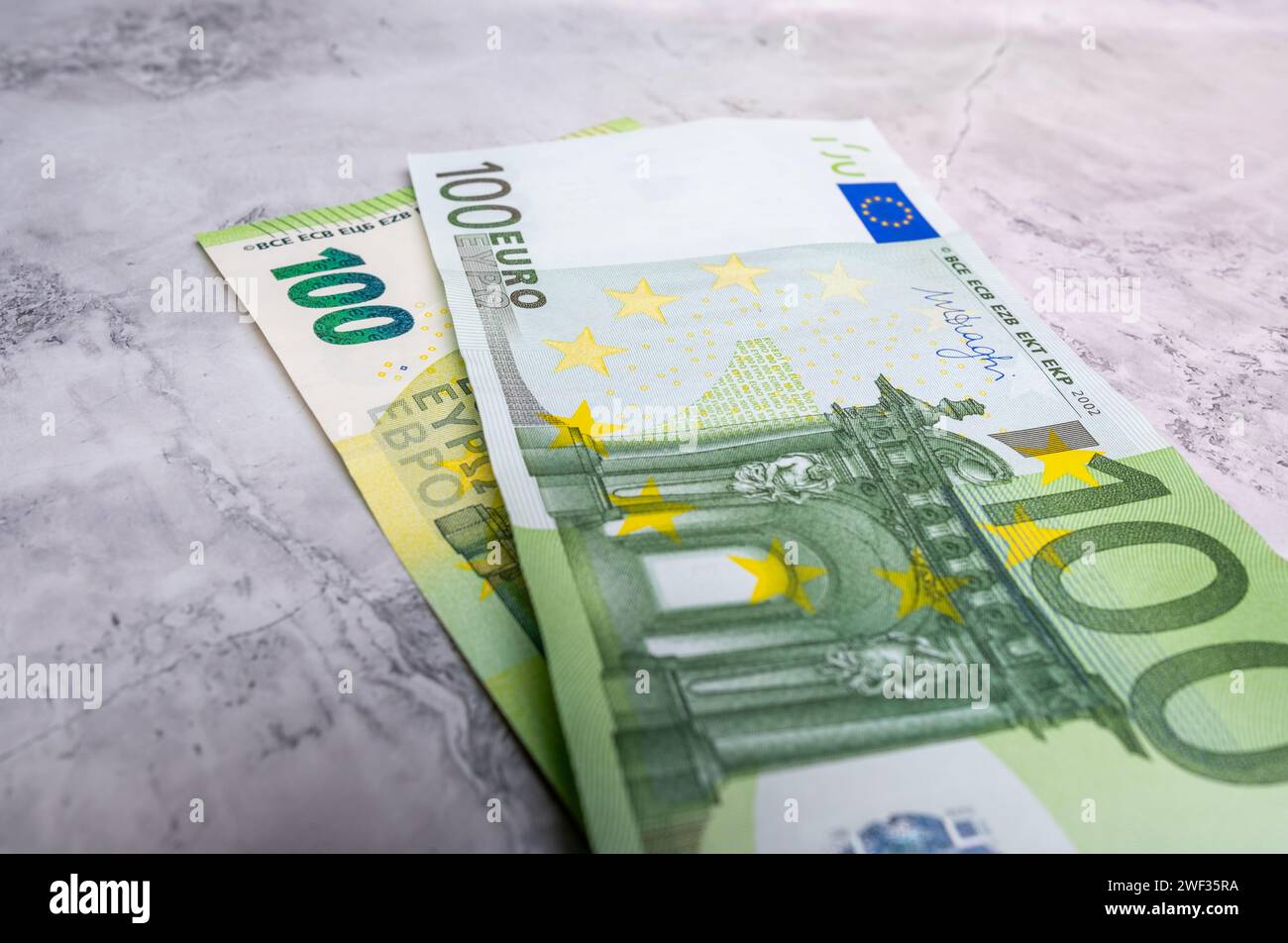 Close-up high quality photo of a 100 Euro banknote isolated on the background. Euro banknotes, inflation and price increases. Savings and investme Stock Photo