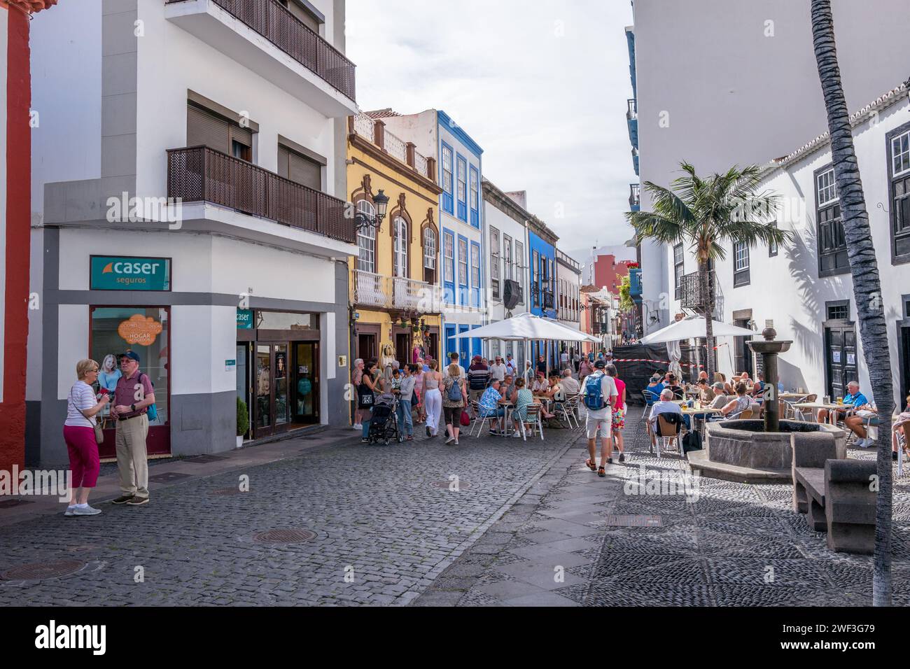 The main Santa Cruz tourist street with shops, cafes and colourful buildings is Calle Real on the canary island of La Palma. Stock Photo