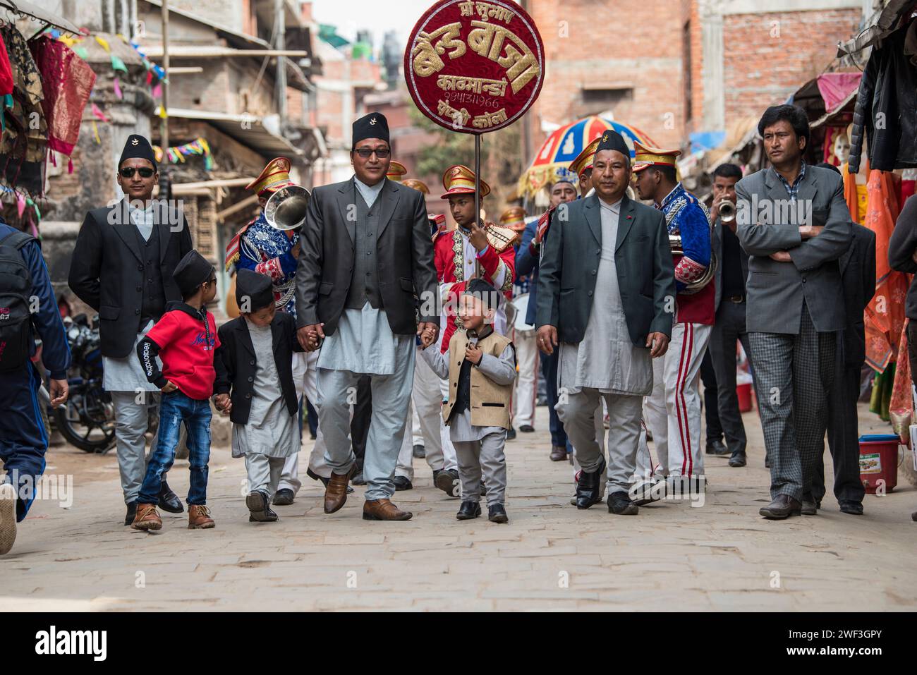 Kathmandu, Nepal- March 20,2023 : The wedding procession passes through the streets of the Patan Durbar Square with brass music. Stock Photo