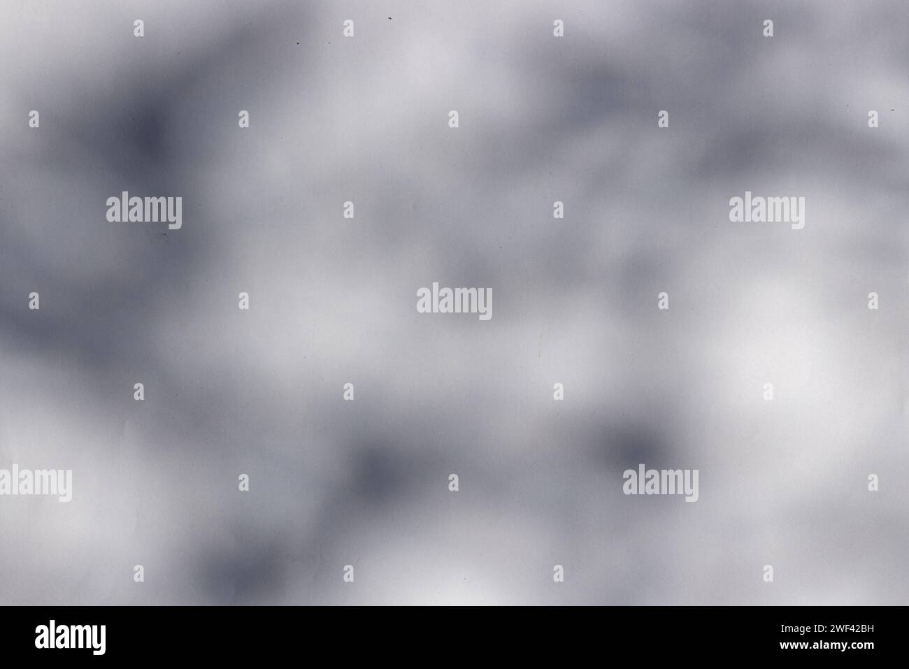 Upward perspective of a dark shadow against a white backdrop. Top perspective of a dark shadow on a white background. Stock Photo