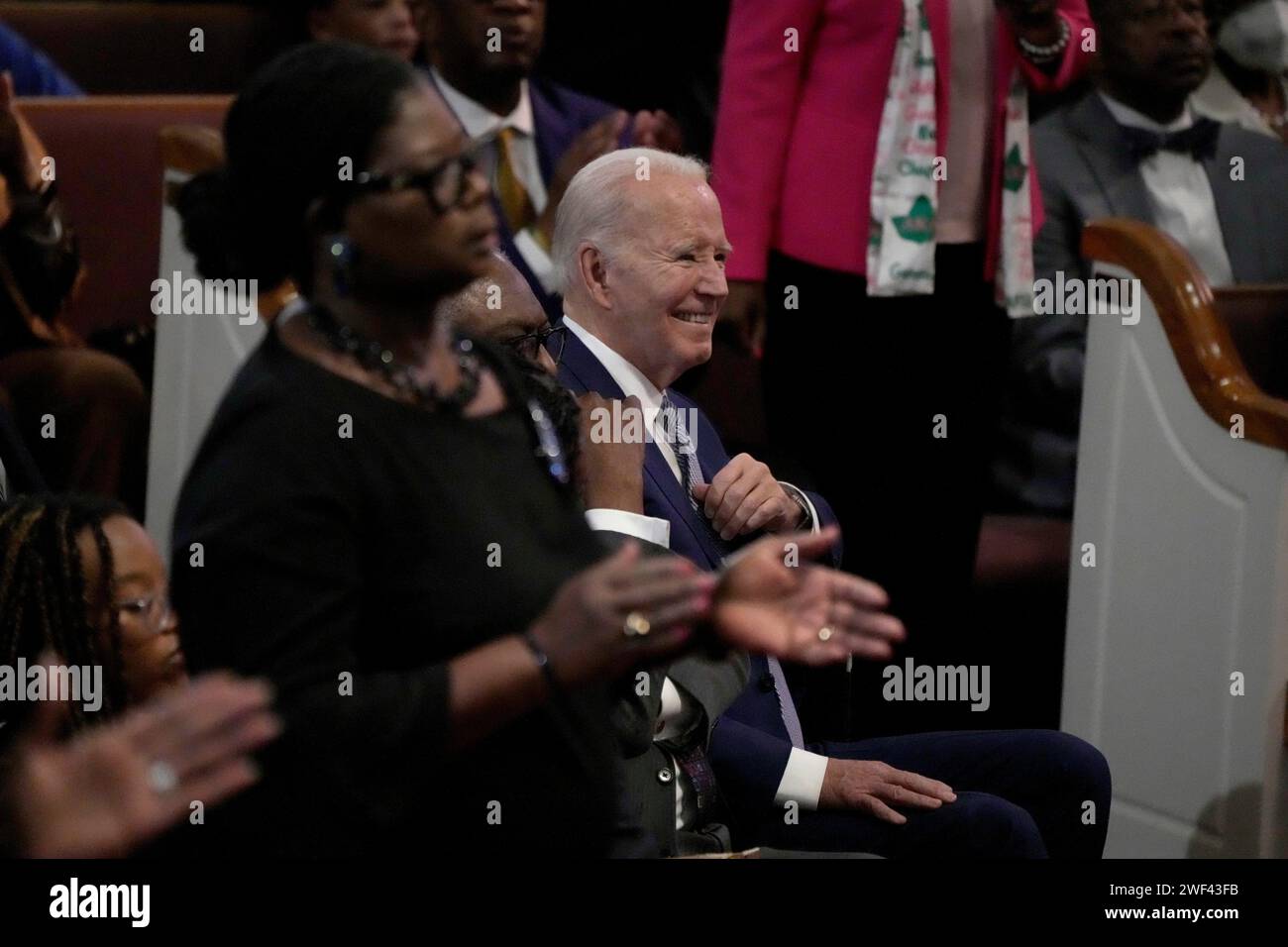 President Joe Biden sits in the audience before speaking at a service ...