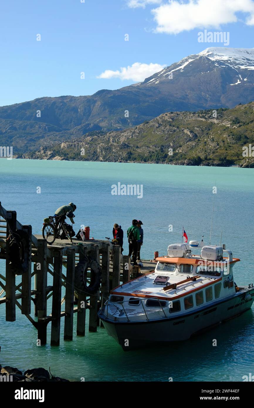 Cyclists and walkers board a boat at Candelario Mancilla ready for the journey across Lago O'Higgins to Bahia Bahamondez and Villa O'Higgins. Stock Photo