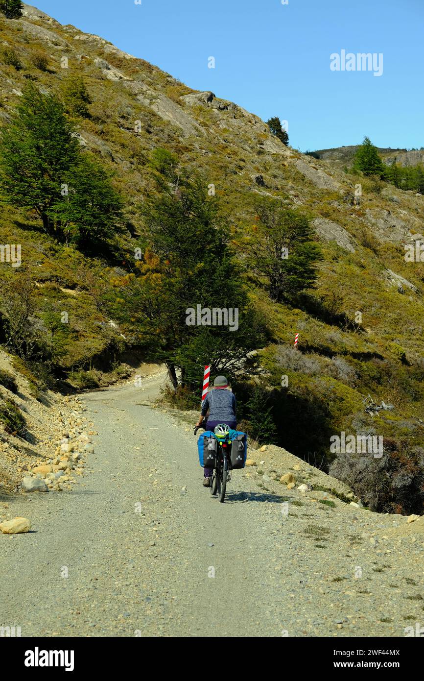Cyclist riding up the rough track from Candelario Mancilla on the 'extension' of the Carretera Austral into Argentina from Chile Stock Photo