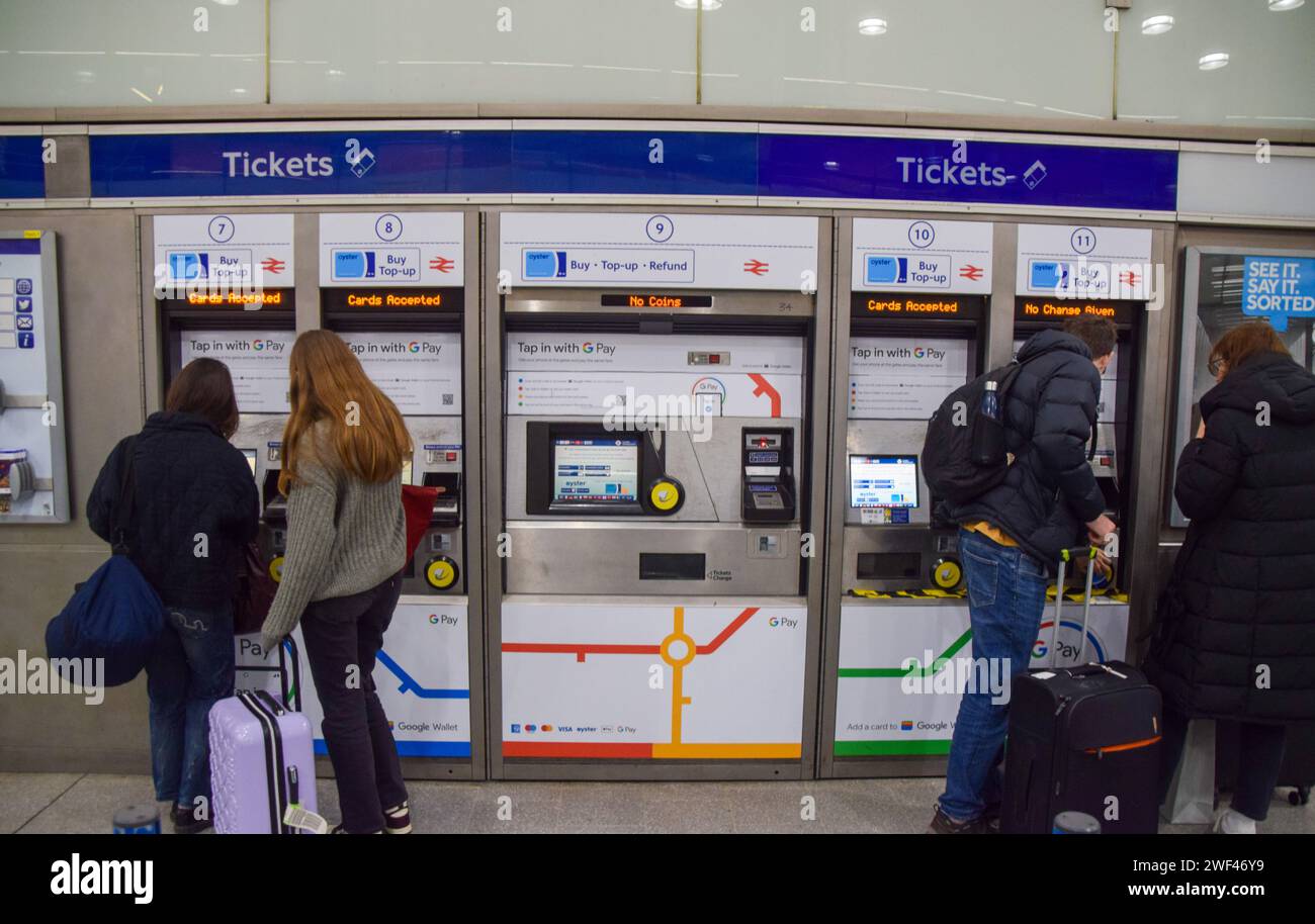 London, England, UK. 28th Jan, 2024. Passengers buy tickets on a