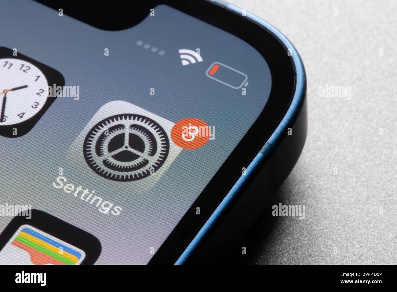 Closeup of the iOS Settings app icon with a notification badge seen on an iPhone. Stock Photo