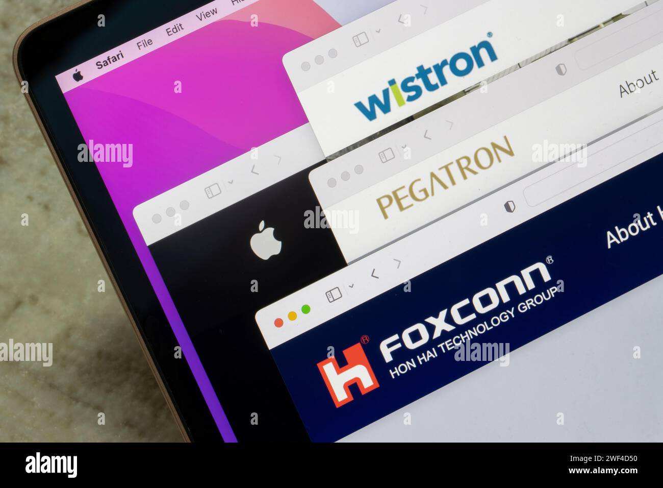 Logos of Apple and its three major Taiwanese suppliers - Foxconn, Pegatron and Wistron - are seen respectively on their websites on a MacBook computer. Stock Photo