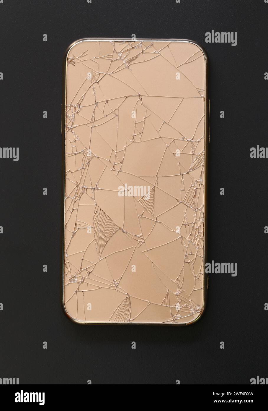 Broken mobile phone cases on black background. Stock Photo