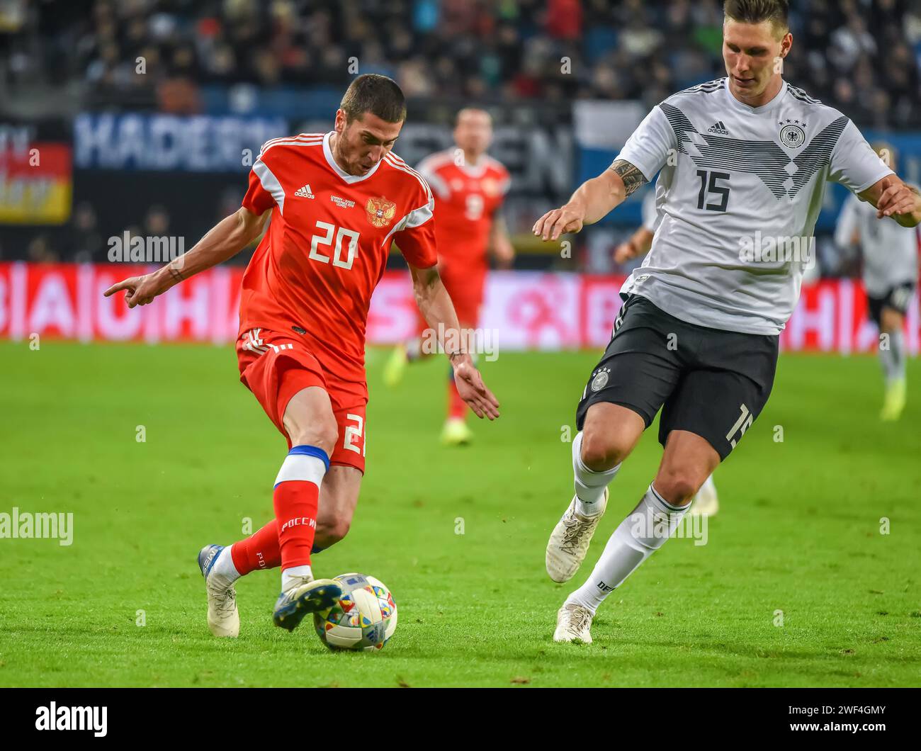 Leipzig, Germany – November 15, 2018. Germany national football team centre back Niklas Sule and Russia midfielder Aleksei Ionov during international Stock Photo