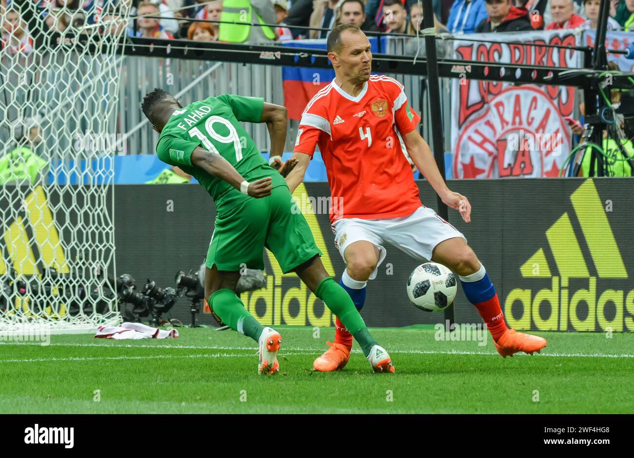 Moscow, Russia – June 14, 2018. Saudi Arabia national football team winger Fahad Almuwallad against Russia player Sergei Ignashevich during opening ma Stock Photo