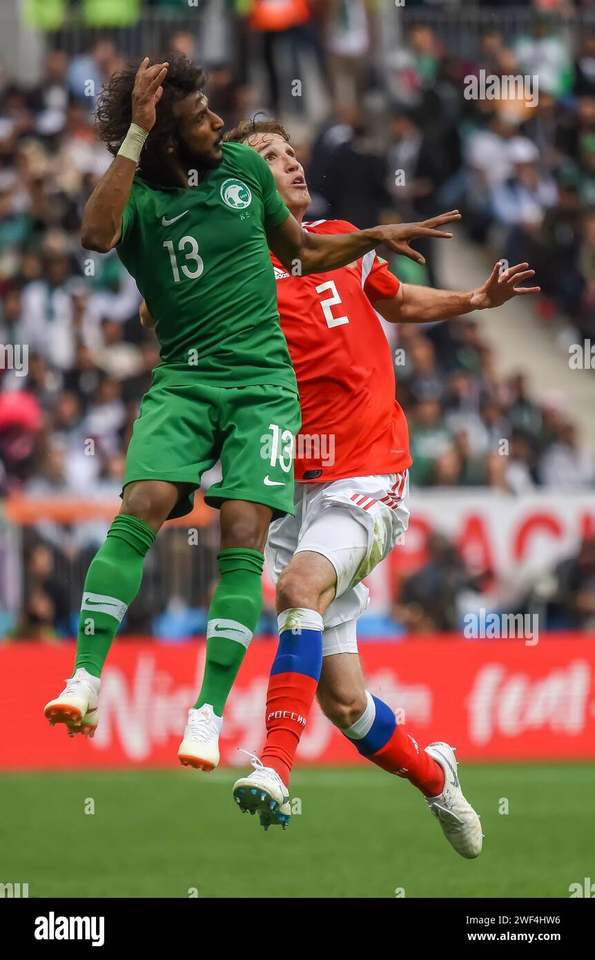 Moscow, Russia – June 14, 2018. Saudi Arabia national football team right-back Yasser Alshahrarani against Russia player Mario Fernandes during openin Stock Photo