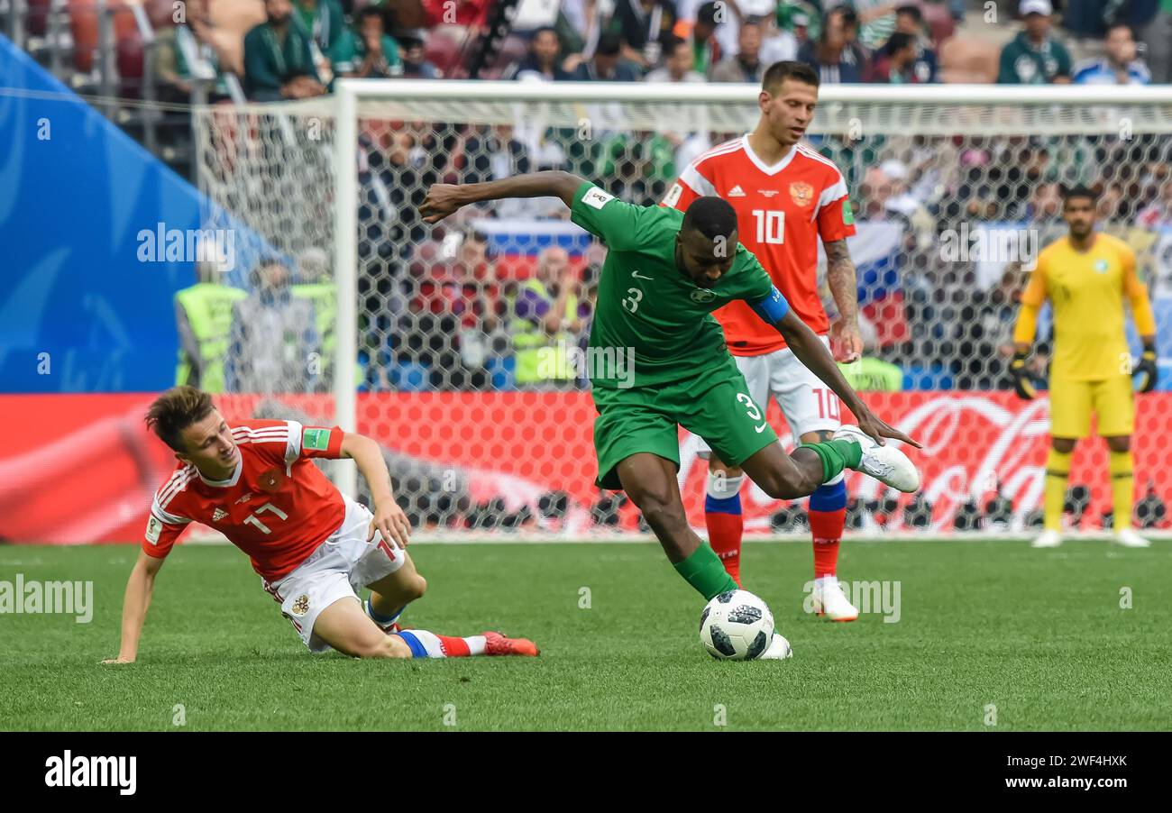 Moscow, Russia – June 14, 2018. Saudi Arabia national football team defender Osama Hawsawi against Russia player Aleksandr Golovin during opening matc Stock Photo