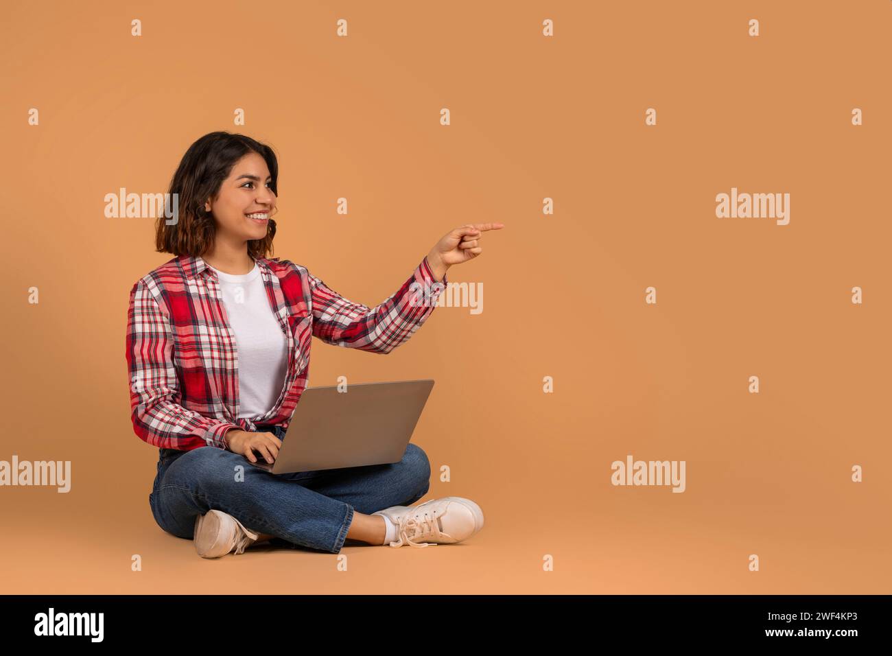 Smiling young middle eastern woman student with laptop Stock Photo