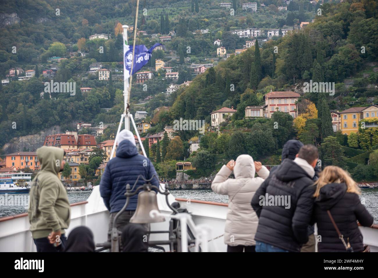 VARENNA, ITALY - OCTOBER 05, 2023 - Tourists waiting for the ferry to dock at the harbor of Varenna, lake Como Stock Photo