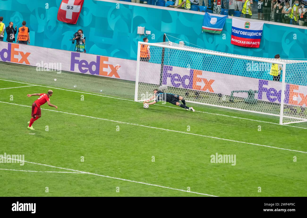 Saint Petersburg, Russia – July 2, 2021. Spain goalkeeper Unai Simon denying a penalty from Switzerland defender Manuel Akanji during penalty shootout Stock Photo