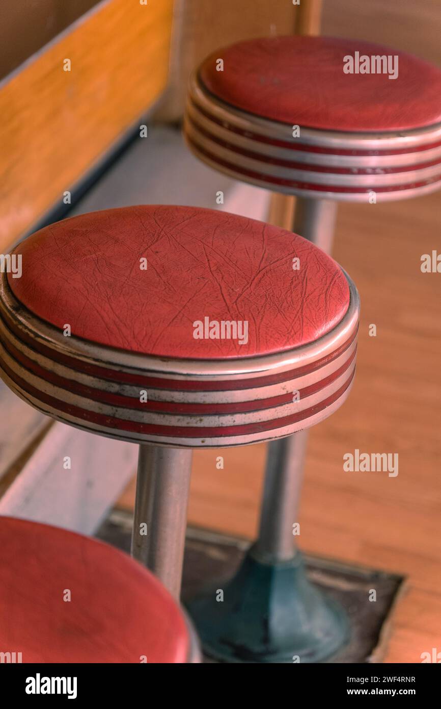 Red vintage bar stools  in retro diner. Stock Photo