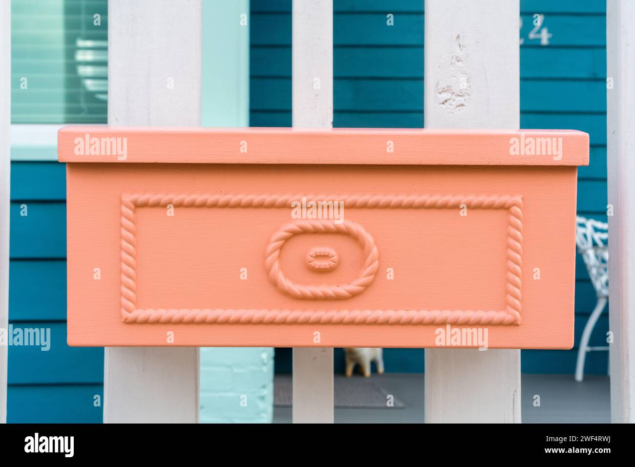 Peach colored vintage mailbox in the color of peach fuzz. Stock Photo