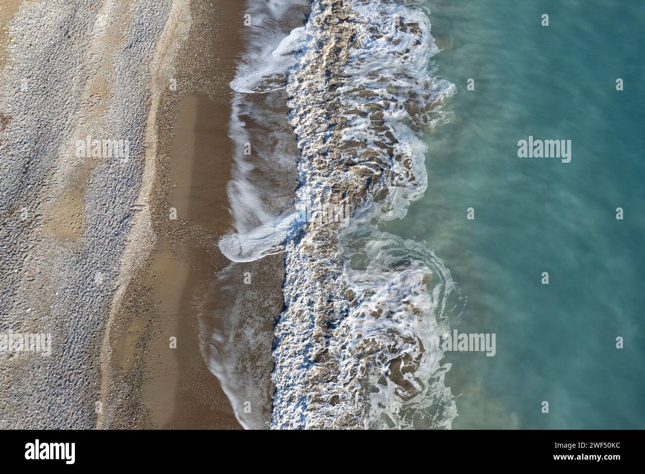 Aerial view of stormy ocean waves breaking on a beach. Nature ...