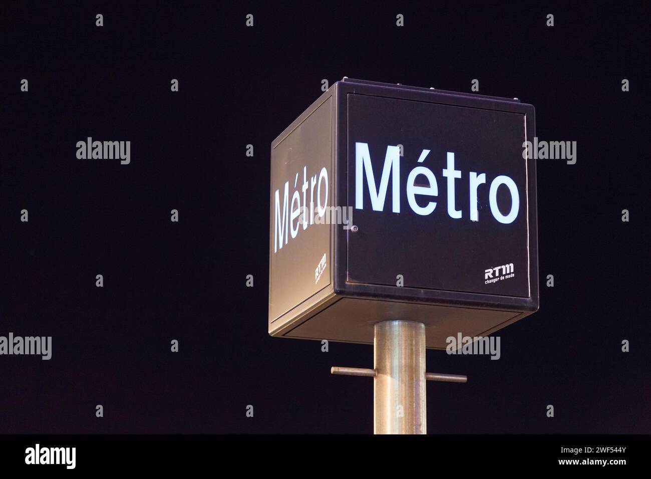 Marseille, France - March 22 2019: Illuminated Marseille Metro (French: Métro de Marseille) outside of a subway station. RTM is the accronym of 'Régie Stock Photo