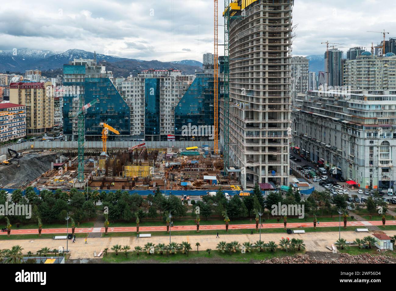 Aerial view of construction site with tower cranes working and building ...
