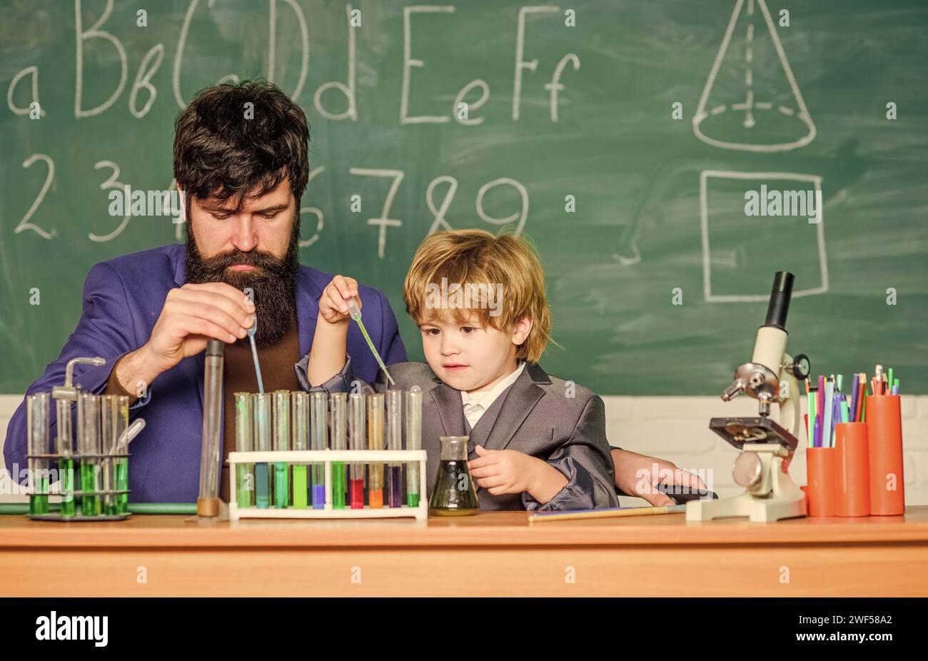 Perseverance pays off. Chemical experiment. Symptoms of ADHD at school. Educational school program. Schoolboy cute child experimenting with liquids Stock Photo