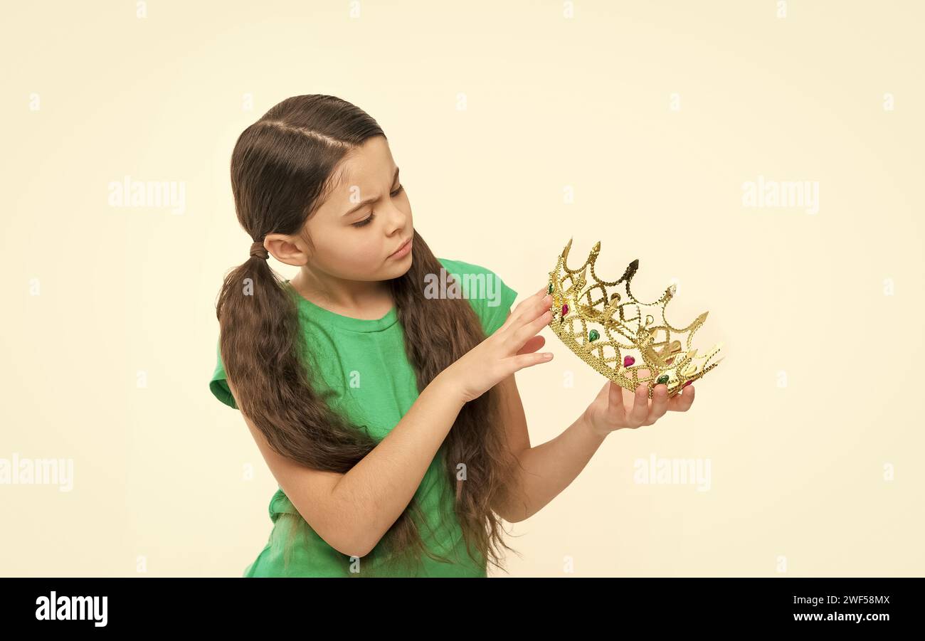 looking for gem. kid imagine she is big boss. reason to be proud. dreams come true. I am a champion. small girl going to try on a crown. born to win Stock Photo