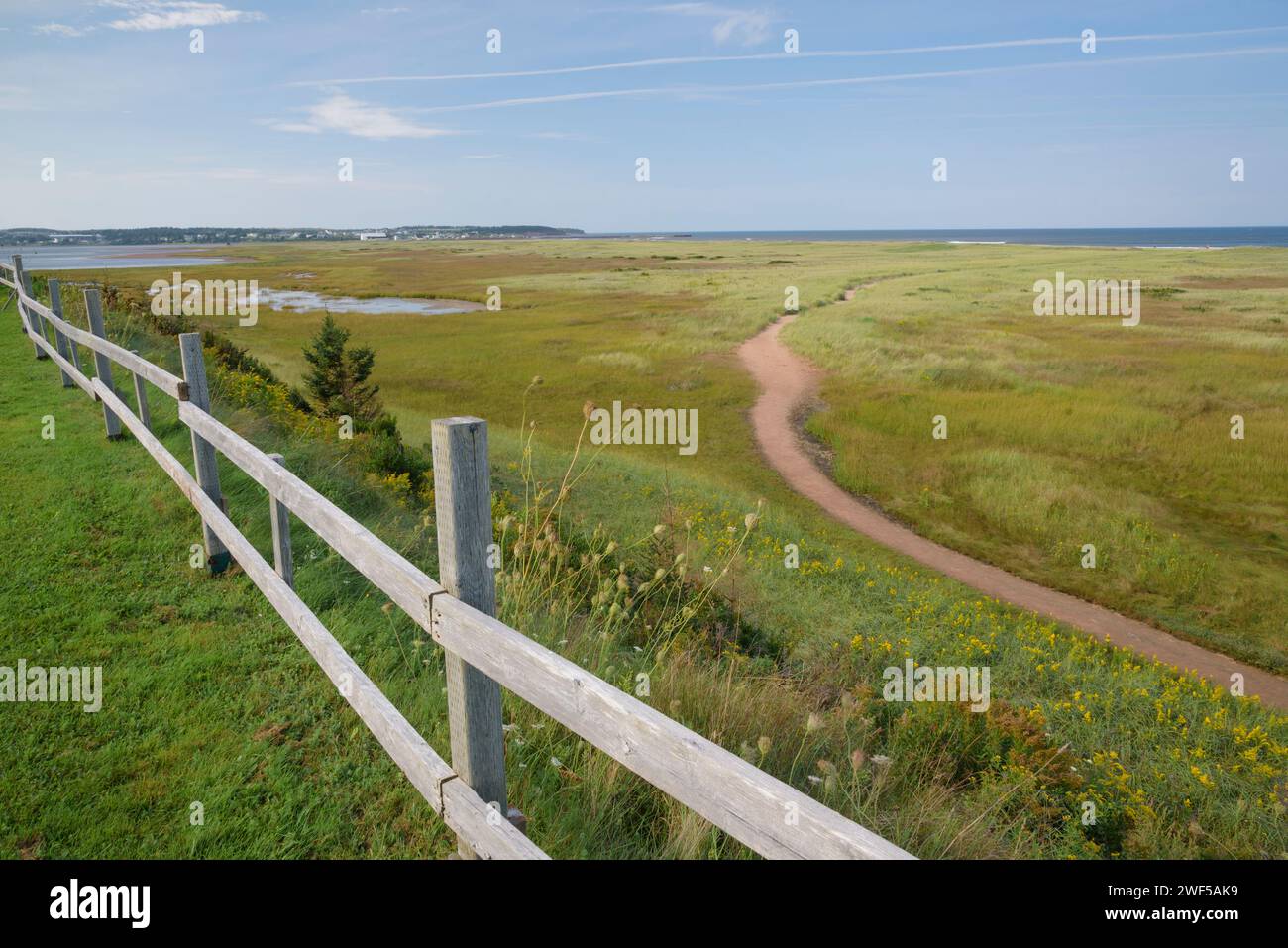 Sandy path leading to the Atlantic Ocean, South Rustico, Prince Edward Island, Canada. North Rustico harbour can be seen in the distance. Stock Photo