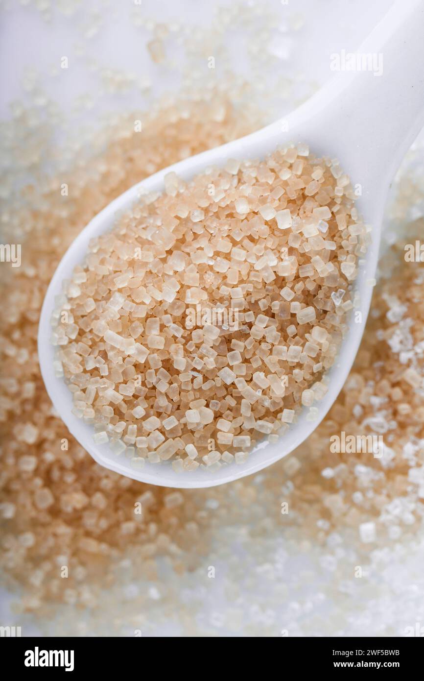 Brown sugar in a teaspoon on white background Stock Photo Alamy
