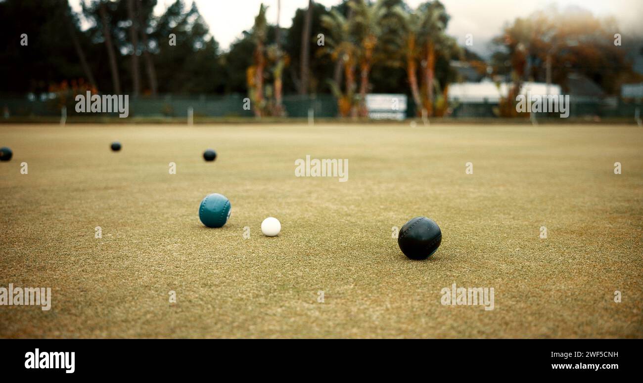 Green, lawn bowling and balls on grass, field or pitch in a match, game or competition of outdoor bowls. Ball, sport and tournament at a bowlers club Stock Photo
