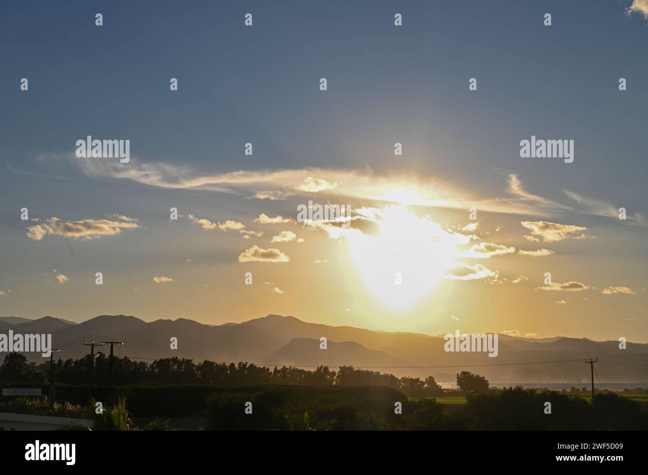 the sun sets behind the mountains in Cyprus 1 Stock Photo