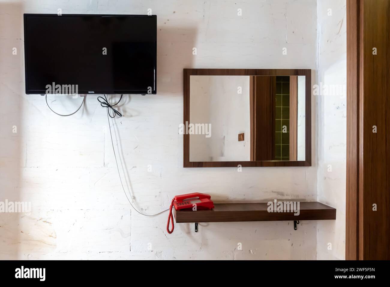 A guest room in Grand Babil Otel Hotel in Sanliurfa Turkey. Simple hotel amenities - tv set, telephone, mirror Stock Photo