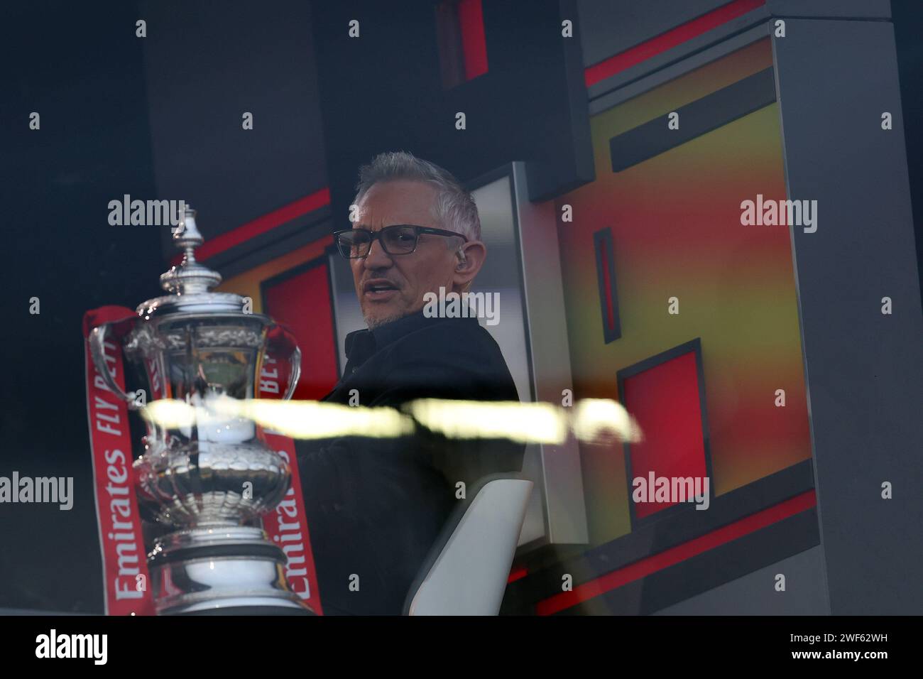 Newport, UK. 28th Jan, 2024. Gary Lineker, sat next to the Emirates FA cup  trophy, looks on from the BBC TV studio. Emirates FA Cup, 4th round match,  Newport County v Manchester