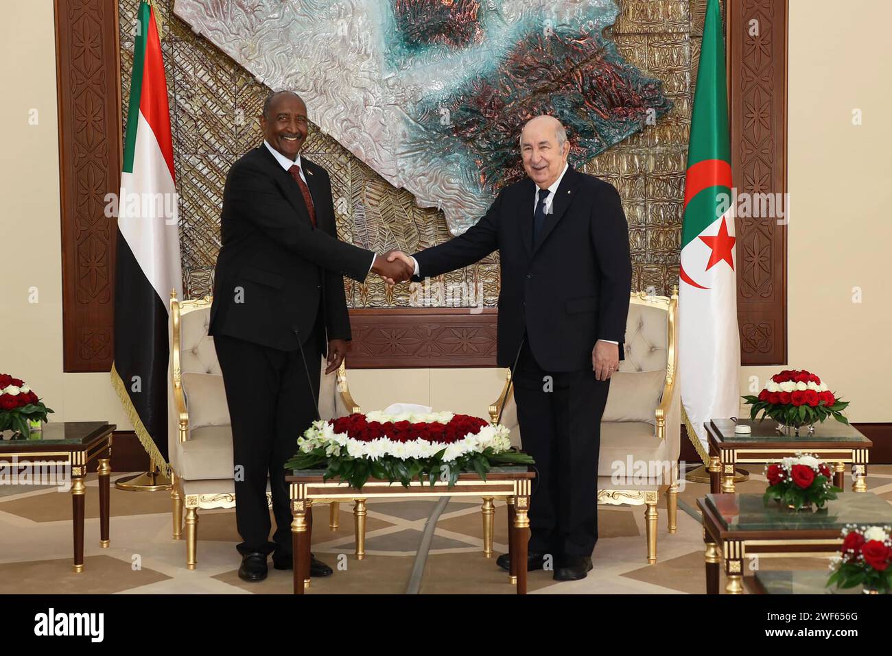 (240129) -- ALGIERS, Jan. 29, 2024 (Xinhua) -- Algerian President Abdelmadjid Tebboune (R) shakes hands with visiting Chairman of Sudan's Transitional Sovereign Council Abdel Fattah Al-Burhan, also the general commander of the Sudanese Armed Forces, in Algiers, Algeria, Jan. 28, 2024. Algerian President Abdelmadjid Tebboune on Sunday reiterated his country's unwavering support for Sudan. Tebboune made the remarks at a joint press conference in Algiers with visiting Chairman of Sudan's Transitional Sovereign Council Abdel Fattah Al-Burhan. (Algerian Presidency/Handout via Xinhua) Stock Photo