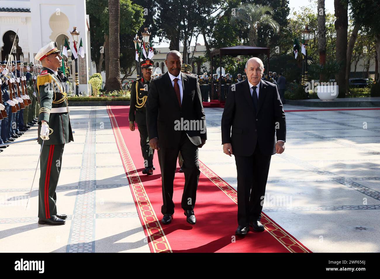 (240129) -- ALGIERS, Jan. 29, 2024 (Xinhua) -- Algerian President Abdelmadjid Tebboune (R) welcomes visiting Chairman of Sudan's Transitional Sovereign Council Abdel Fattah Al-Burhan, also the general commander of the Sudanese Armed Forces, in Algiers, Algeria, Jan. 28, 2024. Algerian President Abdelmadjid Tebboune on Sunday reiterated his country's unwavering support for Sudan. Tebboune made the remarks at a joint press conference in Algiers with visiting Chairman of Sudan's Transitional Sovereign Council Abdel Fattah Al-Burhan. (Algerian Presidency/Handout via Xinhua) Stock Photo