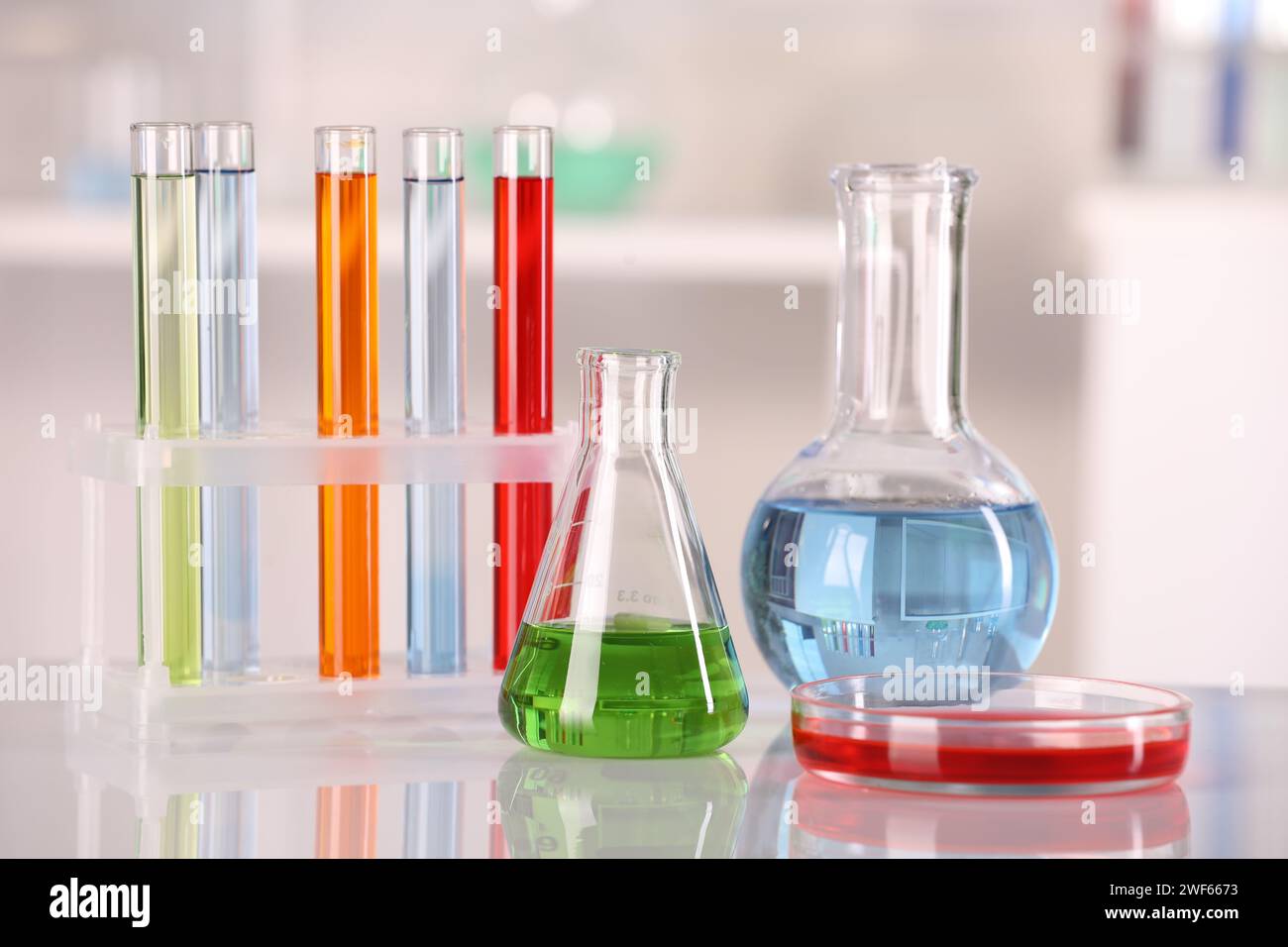 Laboratory analysis. Glass flasks, Petri dish and test tubes with ...
