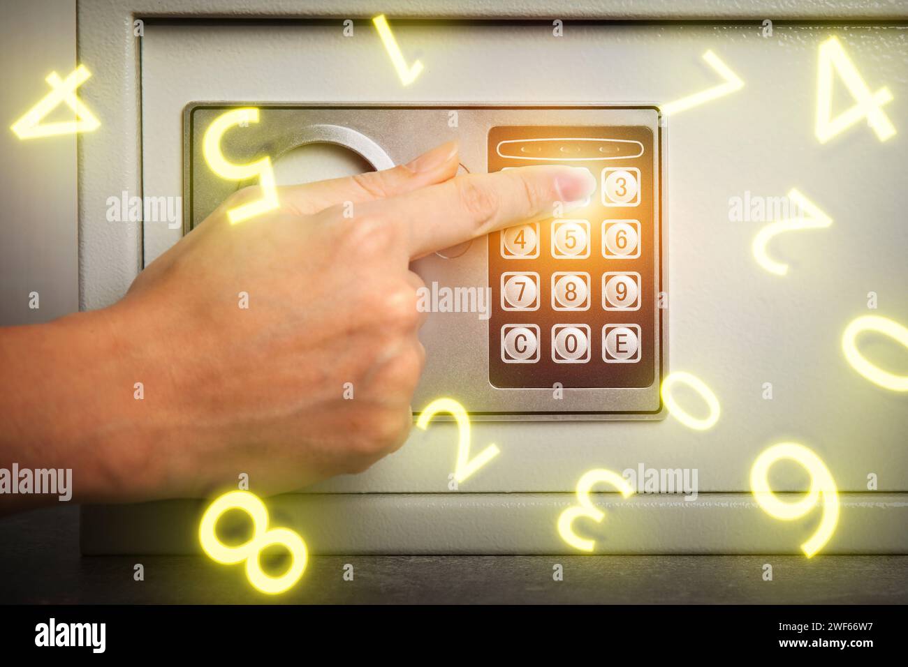 Woman pressing buttons on keypad to lock steel safe, closeup. Numbers ...