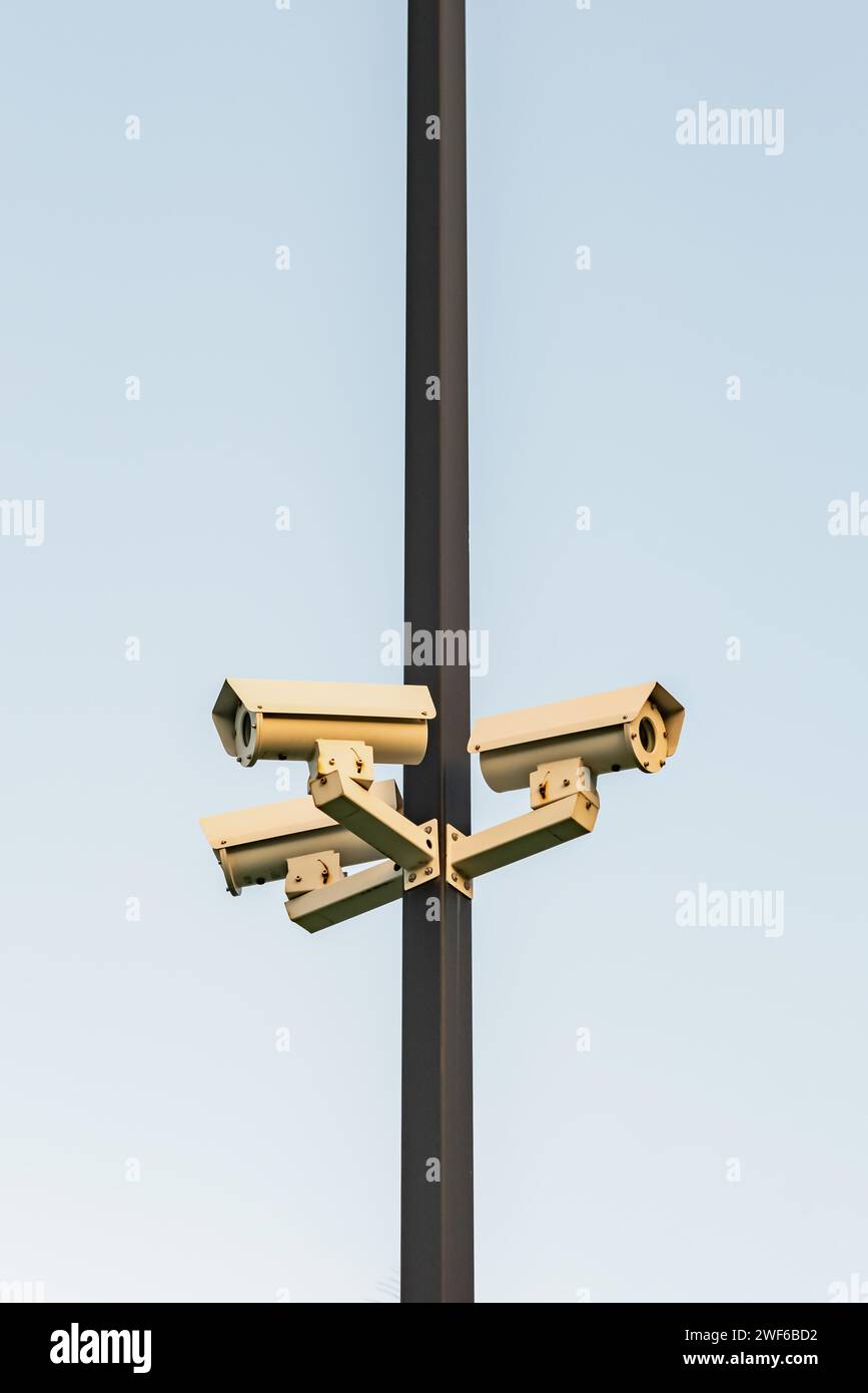 Security surveillance video cameras on pole safety protection monitoring crime three directions Stock Photo