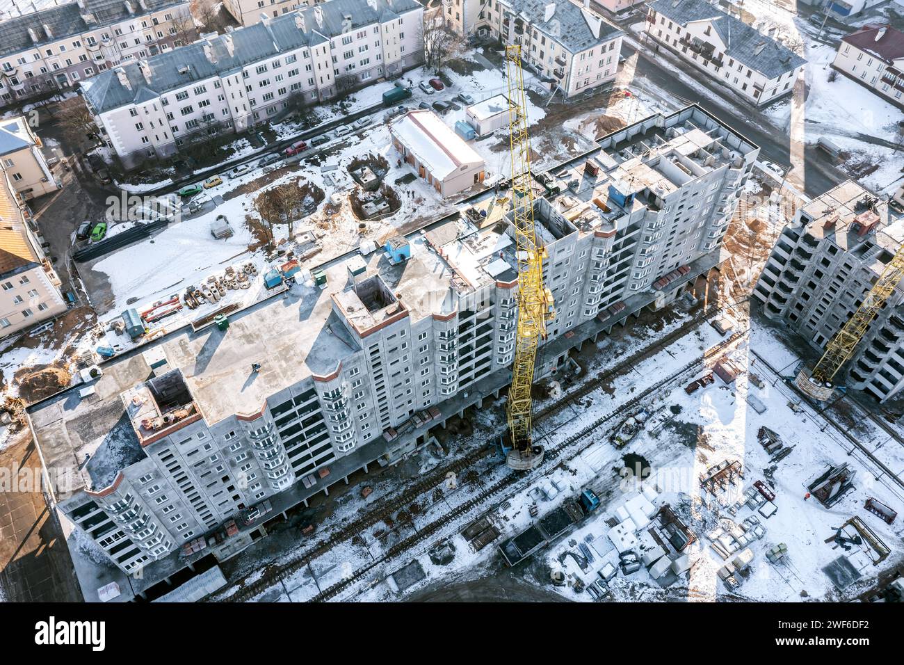 aerial view of snow-covered construction site. new residential building ...